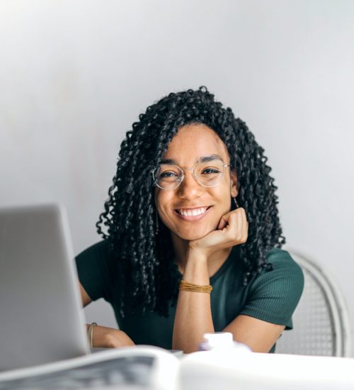 happy-ethnic-woman-sitting-at-table-with-laptop-3769021.jpg